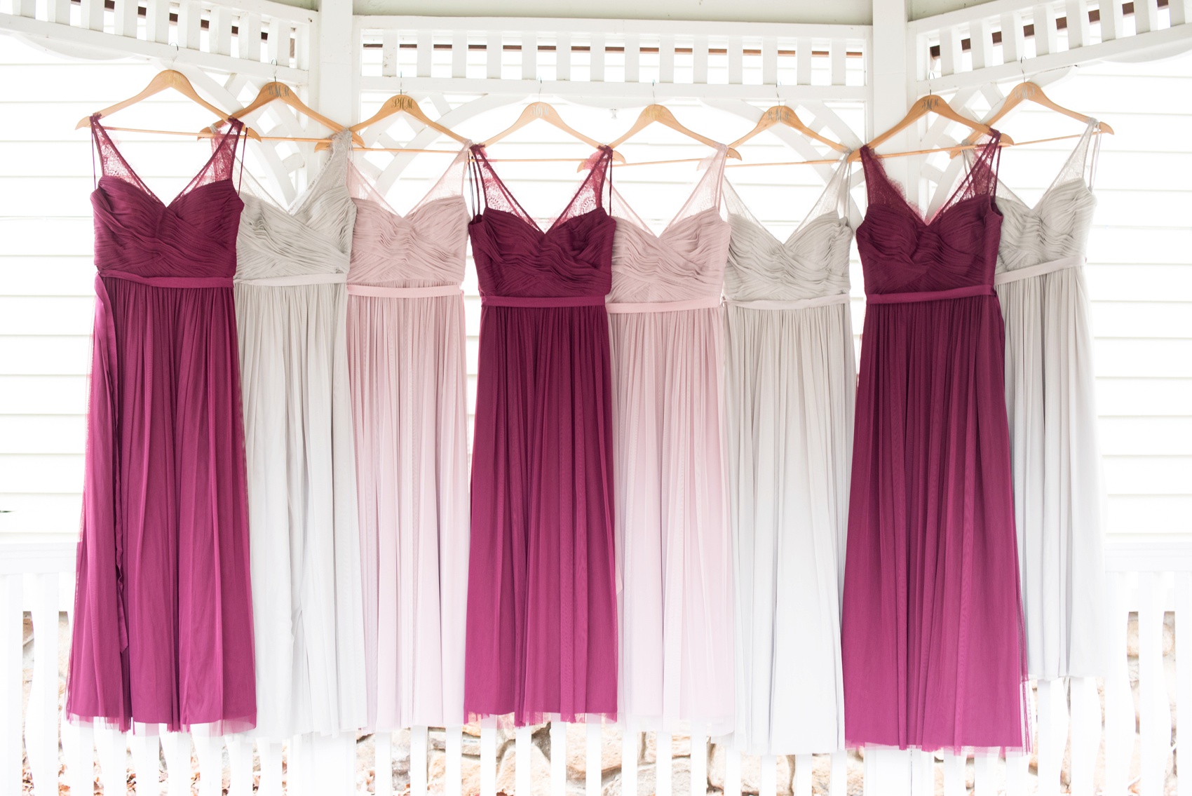 Bridesmaids gowns photo in burgundy, blush and grey by Mikkel Paige Photography, NYC and Raleigh wedding photographer. Wedding at The Olde Mill Inn in New Jersey.