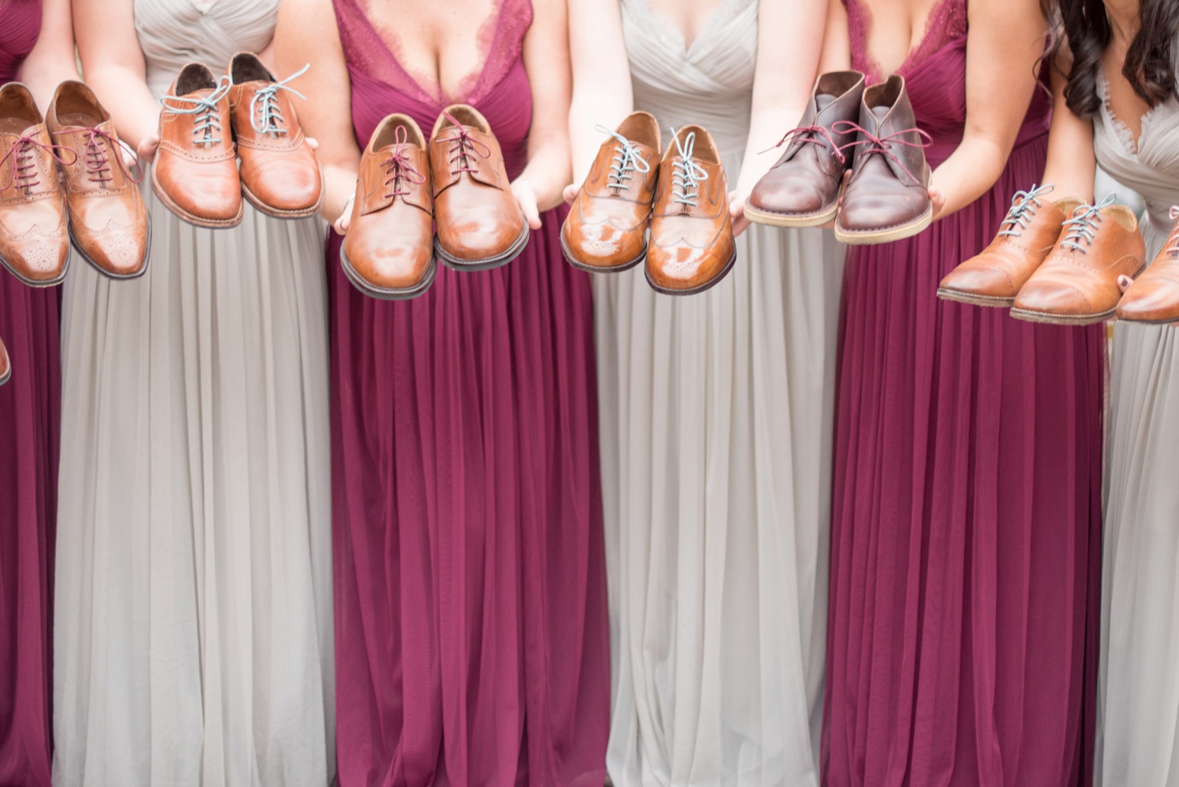 Bridesmaids gowns photo with matching groomsmen shoe laces in burgundy, blush and grey by Mikkel Paige Photography, NYC and Raleigh wedding photographer. Wedding at The Olde Mill Inn in New Jersey.