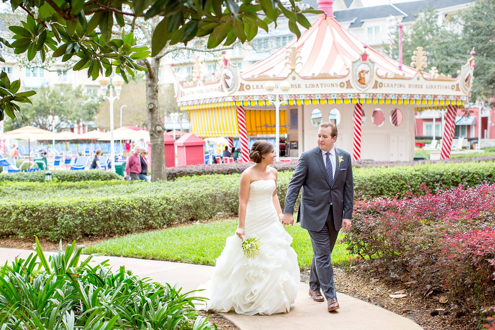 Walt Disney World wedding pictures at the Boardwalk venue, including a waterfront ceremony and Dance Hall reception near Epcot. These photos will give you unique, fun ideas from Glow in the Dark invitations to their Dole Whip flavored cake! Want to see more? Click through to Mikkel Paige Photography for more inspiration from this bride and groom's colorful day! #DisneyWedding #mikkelpaige #disneysboardwalk #DisneyWeddingVenue #DisneyBride #DisneyFan #MickeyEars