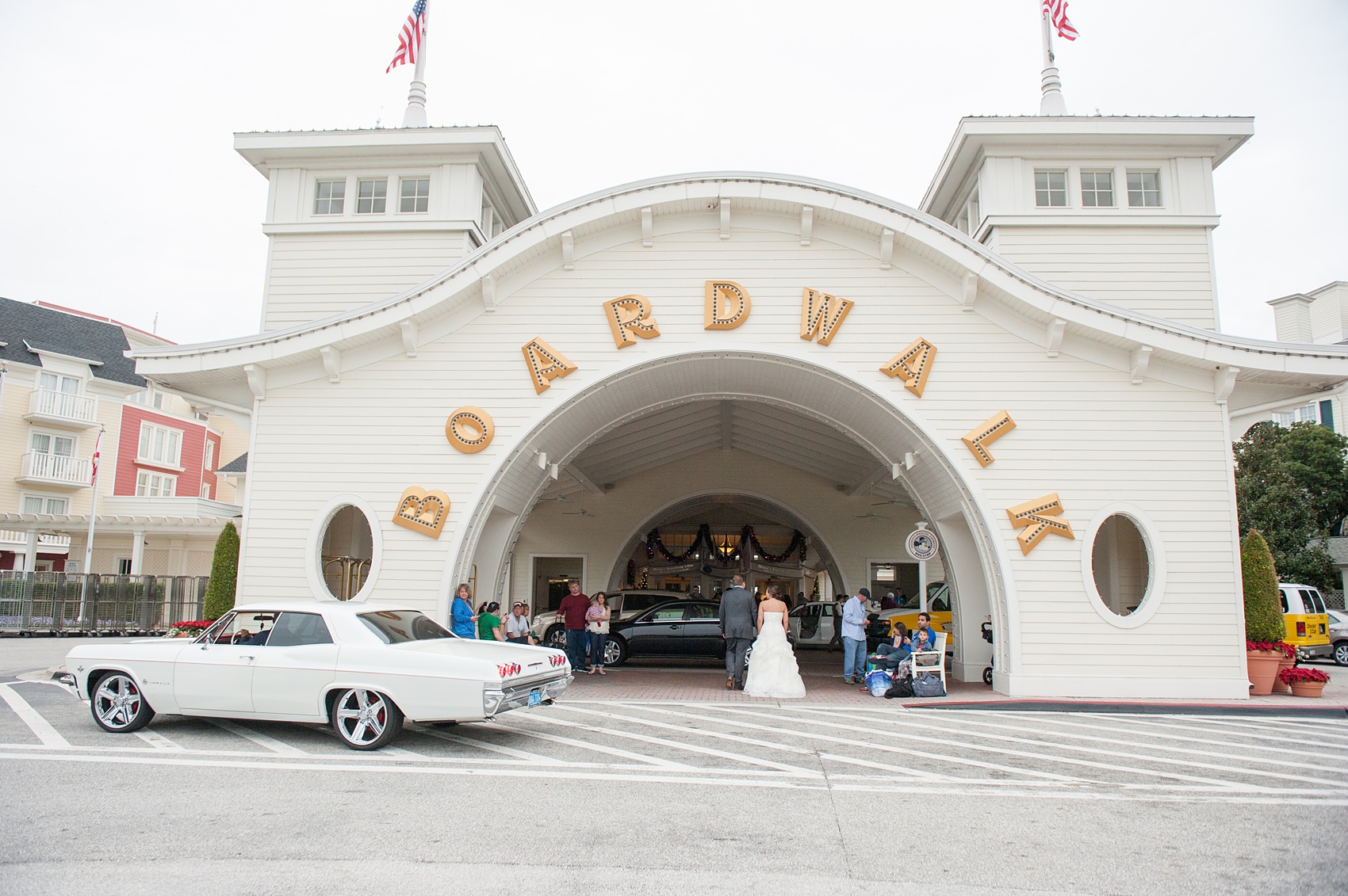 Walt Disney World wedding pictures at the Boardwalk venue, including a waterfront ceremony and Dance Hall reception near Epcot. These photos will give you unique, fun ideas from Glow in the Dark invitations to their Dole Whip flavored cake! Want to see more? Click through to Mikkel Paige Photography for more inspiration from this bride and groom's colorful day! #DisneyWedding #mikkelpaige #disneysboardwalk #DisneyWeddingVenue #DisneyBride #DisneyFan #MickeyEars