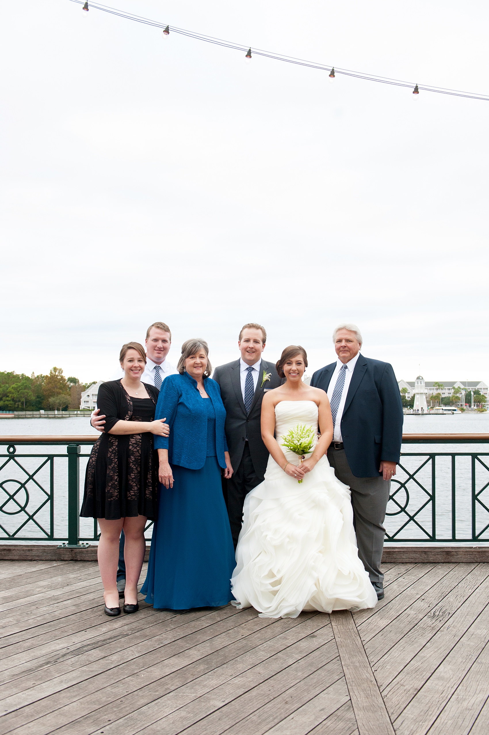 Walt Disney World wedding pictures at the Boardwalk venue, including a waterfront ceremony and Dance Hall reception near Epcot. These photos will give you unique, fun ideas from Glow in the Dark invitations to their Dole Whip flavored cake! Want to see more? Click through to Mikkel Paige Photography for more inspiration from this bride and groom's colorful day! #DisneyWedding #mikkelpaige #disneysboardwalk #DisneyWeddingVenue #DisneyBride #DisneyFan #MickeyEars