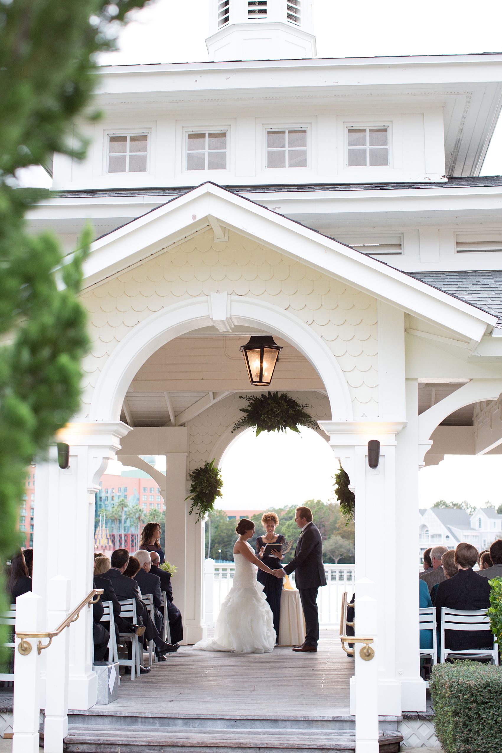 Walt Disney World wedding pictures at the Boardwalk venue, including a waterfront ceremony and Dance Hall reception near Epcot. These photos will give you unique, fun ideas from Glow in the Dark invitations to their Dole Whip flavored cake! Want to see more? Click through to Mikkel Paige Photography for more inspiration from this bride and groom's colorful day! #DisneyWedding #mikkelpaige #disneysboardwalk #DisneyWeddingVenue #DisneyBride #DisneyFan #MickeyEars