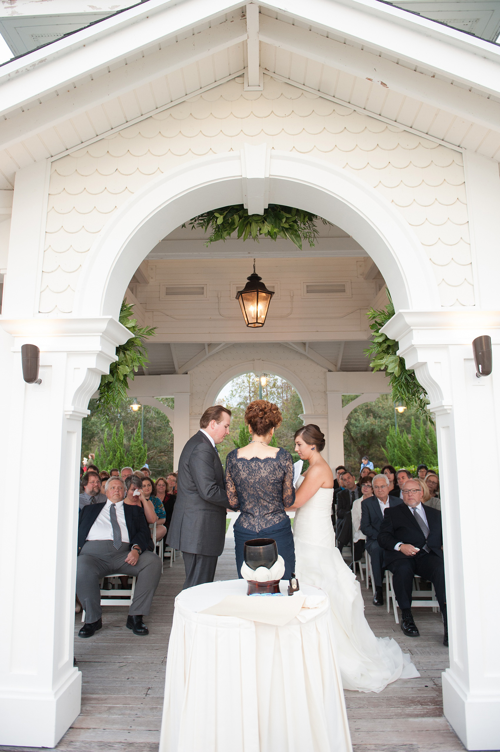 Walt Disney World wedding pictures at the Boardwalk venue, including a waterfront ceremony and Dance Hall reception near Epcot. These photos will give you unique, fun ideas from Glow in the Dark invitations to their Dole Whip flavored cake! Want to see more? Click through to Mikkel Paige Photography for more inspiration from this bride and groom's colorful day! #DisneyWedding #mikkelpaige #disneysboardwalk #DisneyWeddingVenue #DisneyBride #DisneyFan #MickeyEars