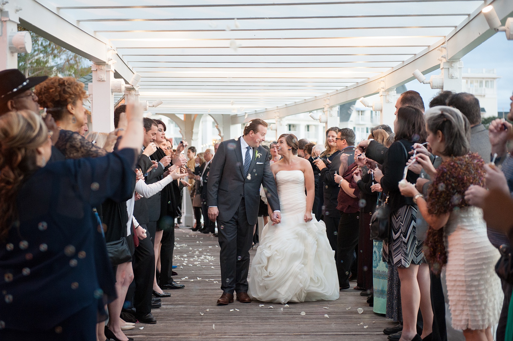 Walt Disney World wedding pictures at the Boardwalk venue, including a waterfront ceremony and Dance Hall reception near Epcot. These photos will give you unique, fun ideas from Glow in the Dark invitations to their Dole Whip flavored cake! Want to see more? Click through to Mikkel Paige Photography for more inspiration from this bride and groom's colorful day! #DisneyWedding #mikkelpaige #disneysboardwalk #DisneyWeddingVenue #DisneyBride #DisneyFan #MickeyEars