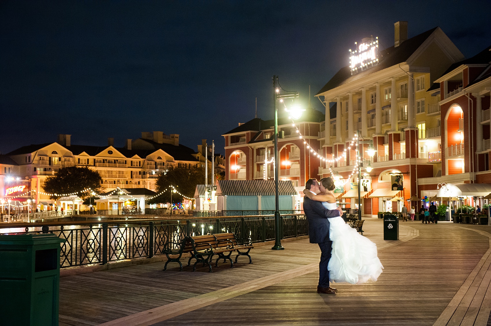 Walt Disney World wedding pictures at the Boardwalk venue, including a waterfront ceremony and Dance Hall reception near Epcot. These photos will give you unique, fun ideas from Glow in the Dark invitations to their Dole Whip flavored cake! Want to see more? Click through to Mikkel Paige Photography for more inspiration from this bride and groom's colorful day! #DisneyWedding #mikkelpaige #disneysboardwalk #DisneyWeddingVenue #DisneyBride #DisneyFan #MickeyEars