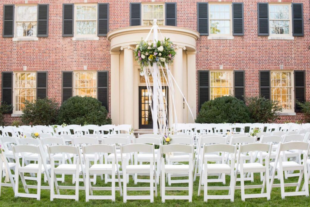 Mikkel Paige Photography photos of The Carolina Inn wedding show. Outdoor ceremony in the round with ribbon may pole.