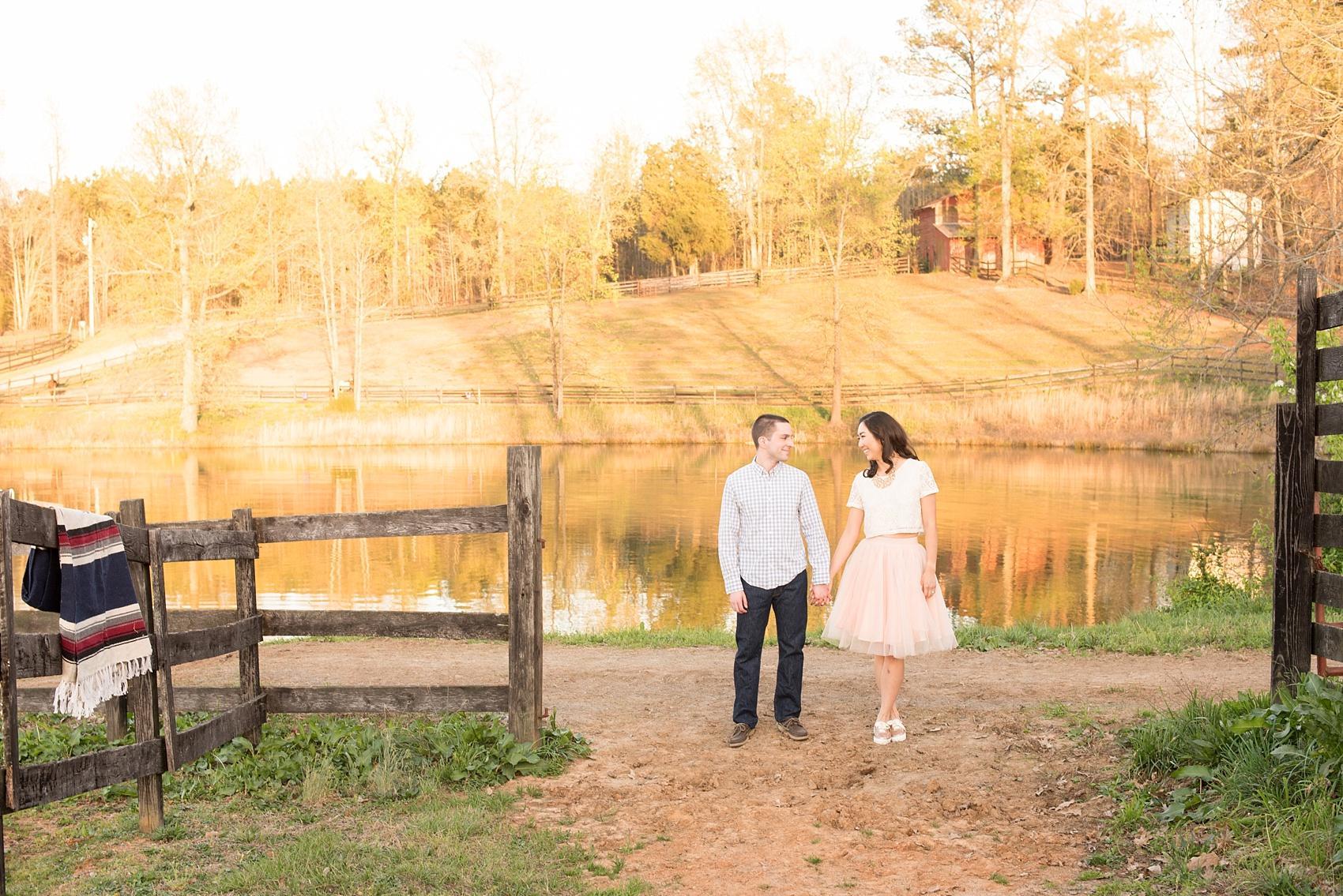 Raleigh farm engagement photos by a lake. Images by Mikkel Paige Photography.