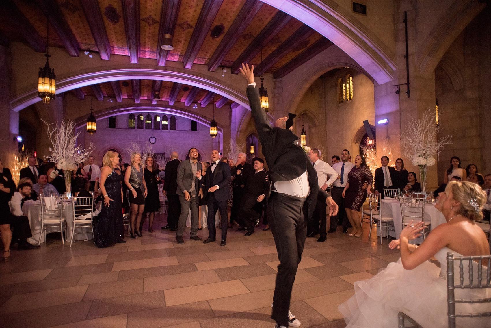 Formal black and white winter wedding reception garter toss. Image by Mikkel Paige Photography for a Riverside Church wedding in NYC on the Upper West Side.