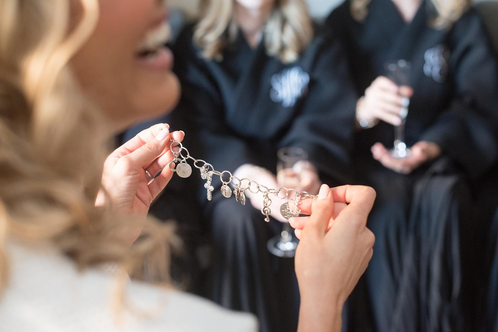 Bride charm bracelet gift photo from her bridesmaids by Mikkel Paige Photography. Image at 1 Hotel Central Park, NYC. 