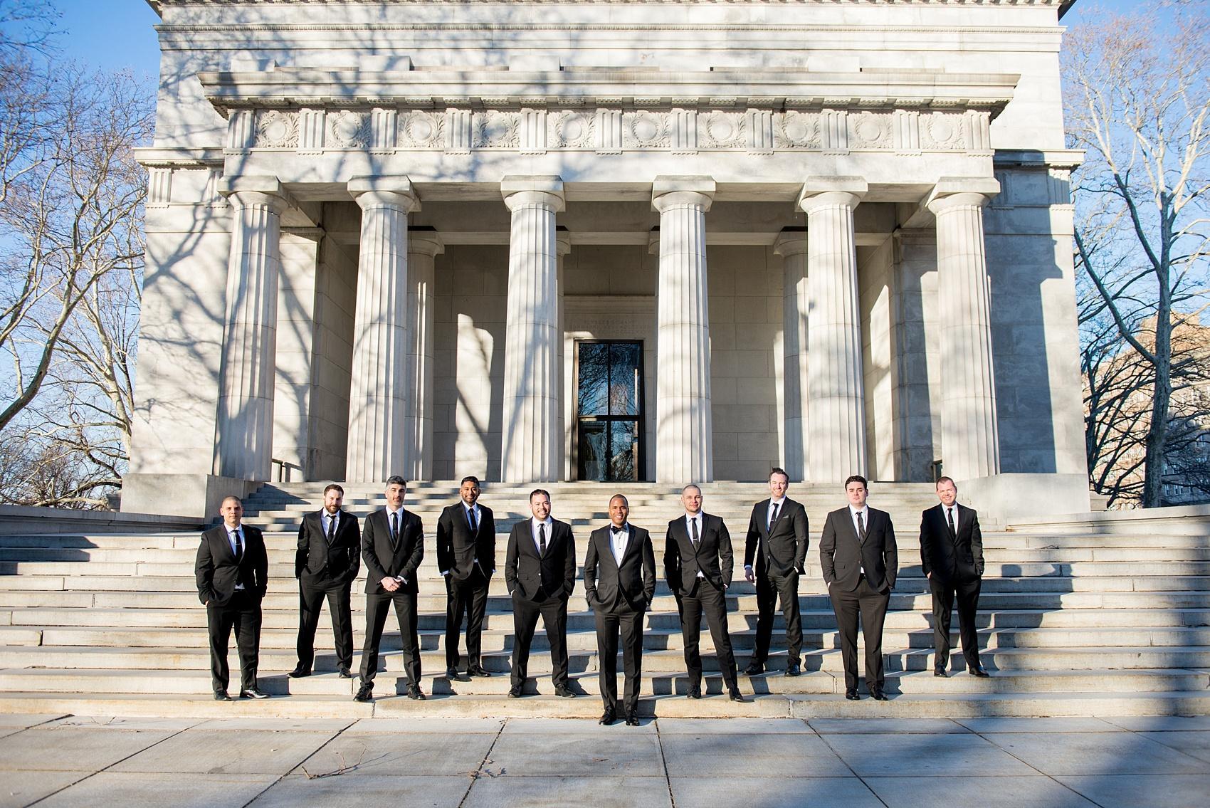 Groomsmen photo with iconic columns on the Upper West Side in NYC. Image by Mikkel Paige Photography.