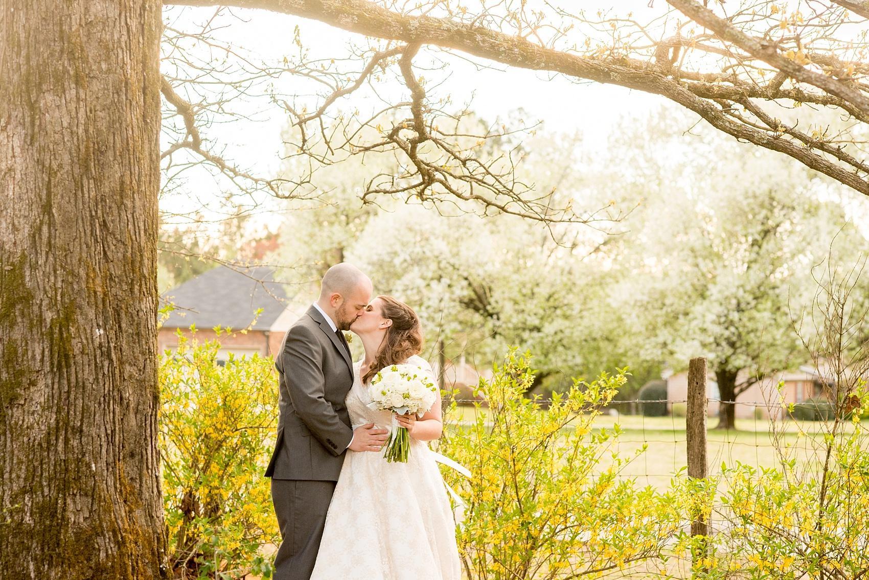 Bride and groom golden hour portraits with yellow spring flowers at their wedding at Four Oaks Manor in Atlanta. Photos by Mikkel Paige Photography.