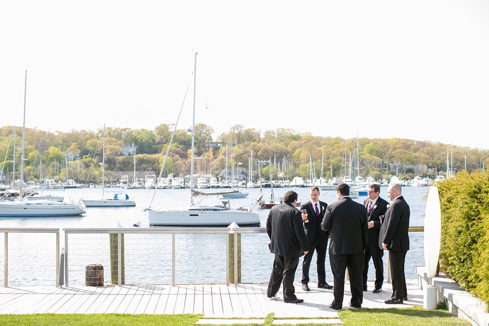 Photos by Mikkel Paige Photography for a wedding at Harbor Club on Long Island. The groomsmen hang out by the waterfront.