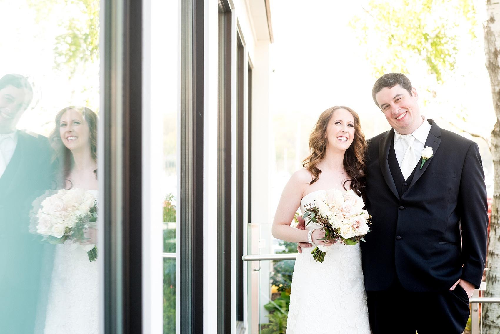 Photos by Mikkel Paige Photography for a wedding at Harbor Club on Long Island. Bride and groom portraits on the balcony overlooking the water.
