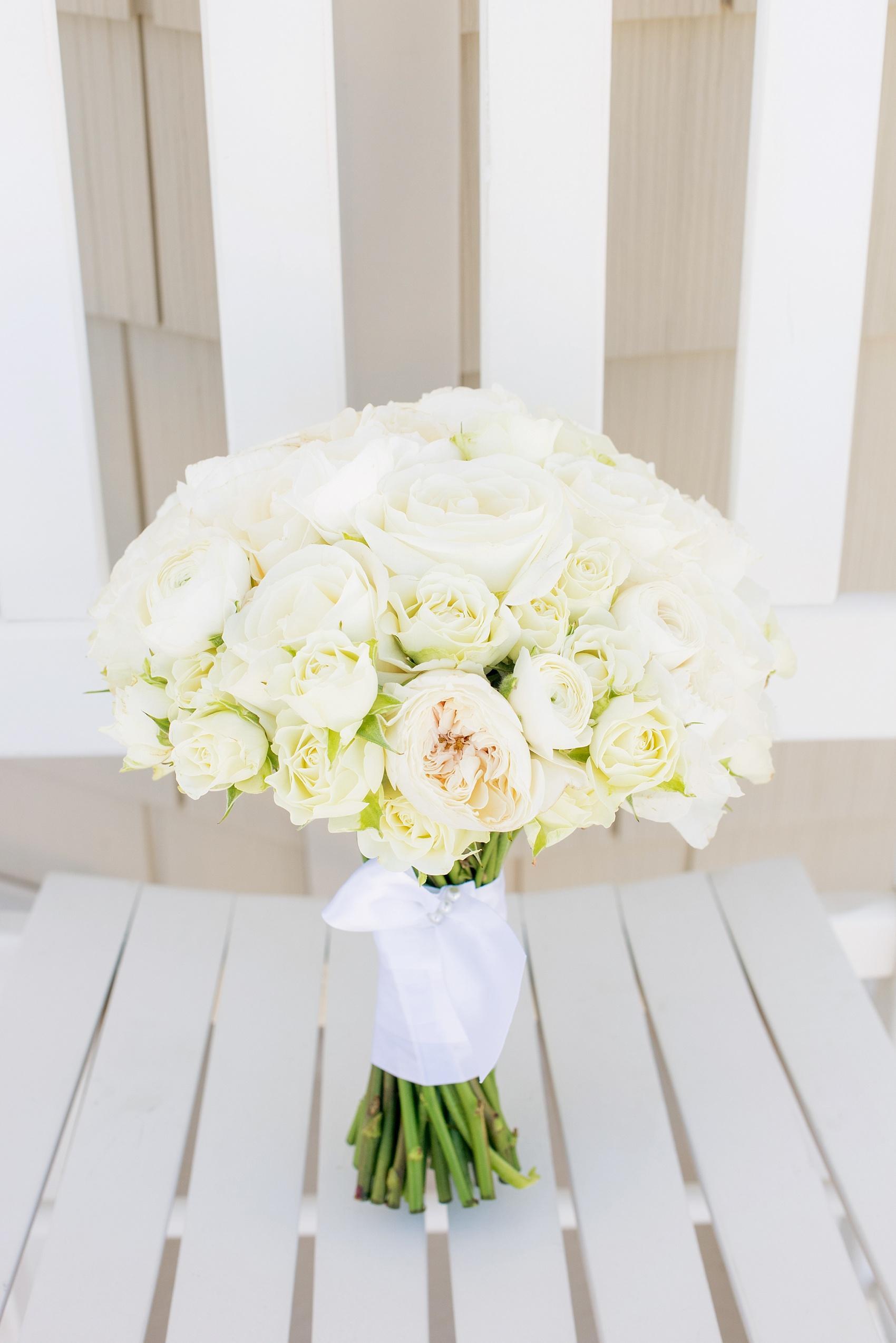 Photo by Mikkel Paige photography. Bride's bouquet of all white garden roses for her beach nuptials.