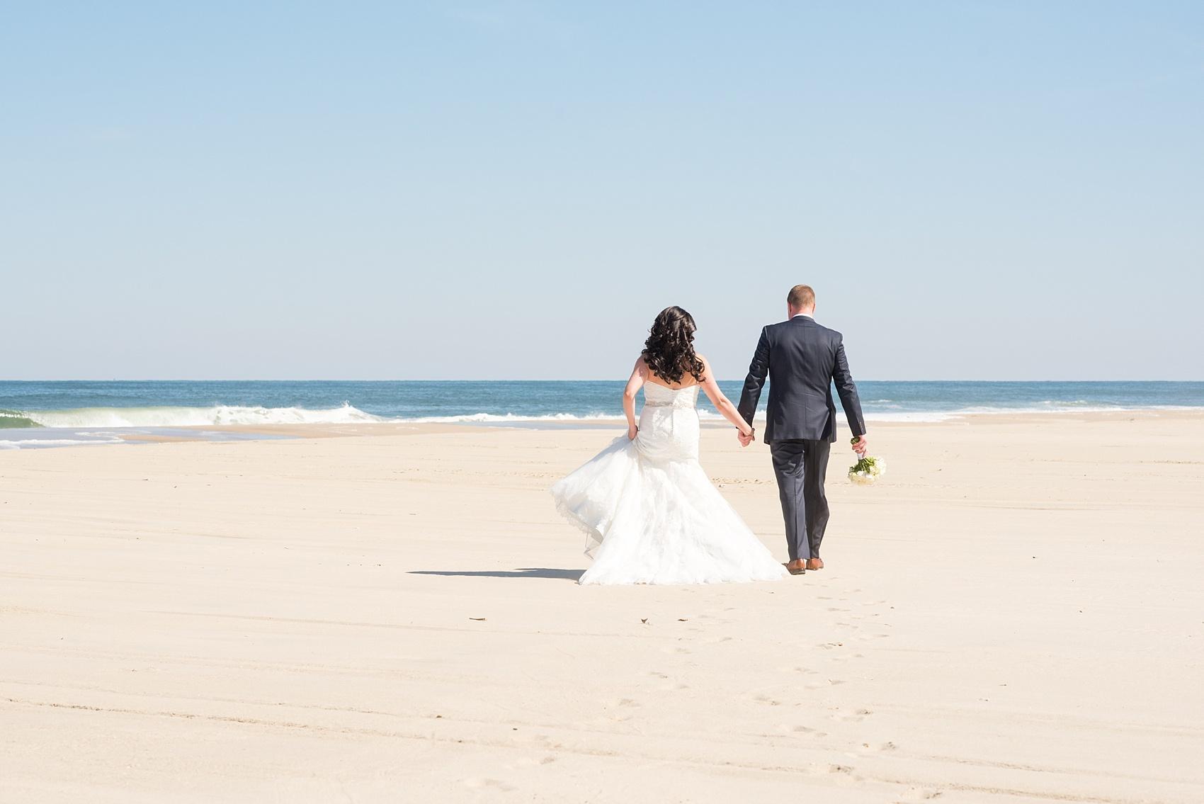 Photo by Mikkel Paige photography. Bride and groom photos on the beach for their spring wedding at Windows on the Water, New Jersey.