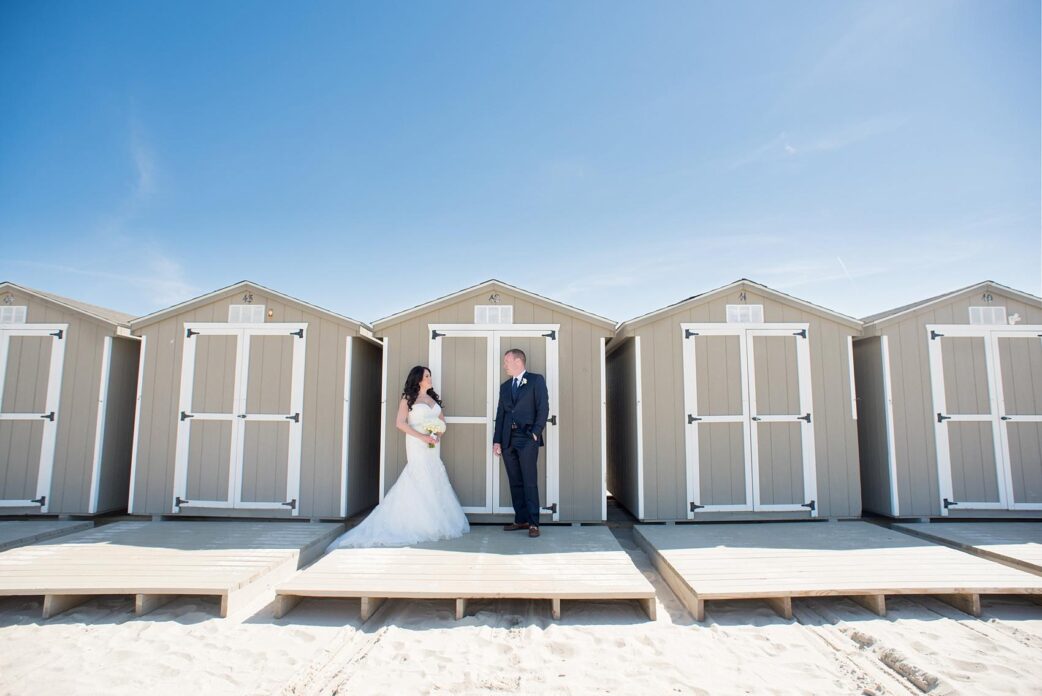 Mikkel Paige Photography image of a wedding at Windows on the Water. Photo of the bride and groom by the beach cabanas.