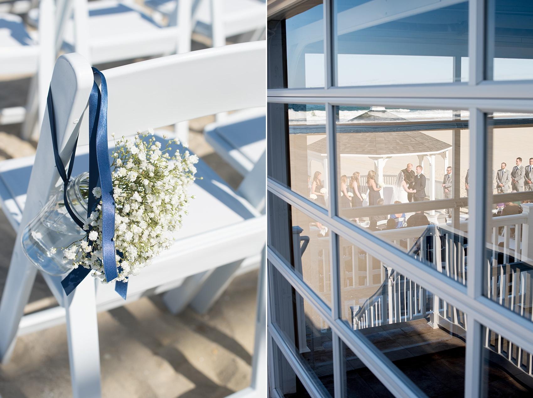 Photo by Mikkel Paige photography. Windows on the Water beach wedding ceremony with navy blue and Baby's Breath flowers.