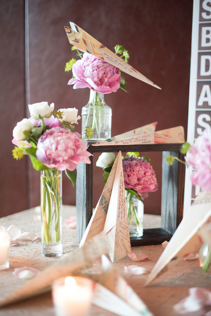 NYC Proposal Photographer Mikkel Paige Photography captures a travel themed marriage proposal in Columbus Circle with calligraphy on paper airplanes.