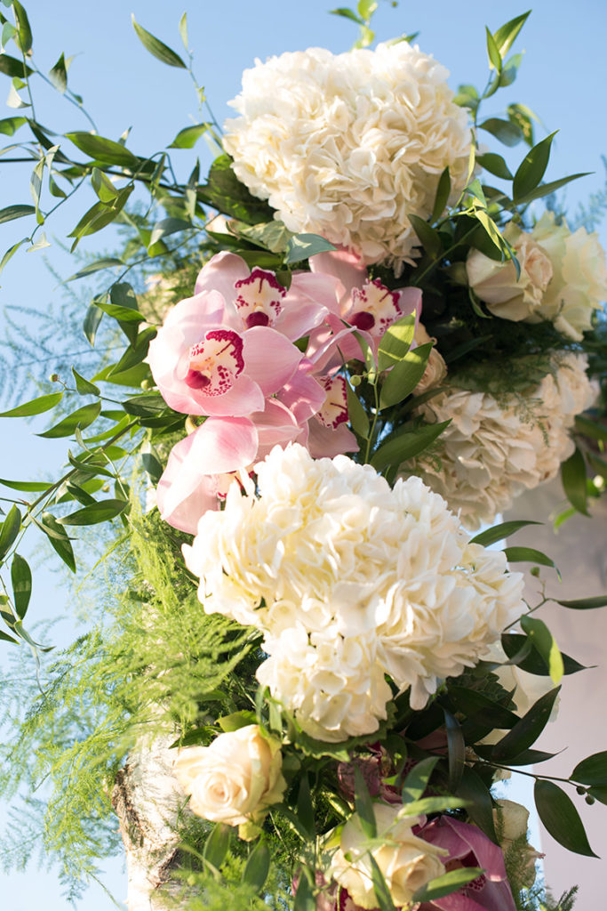 NYC rooftop proposal photos by Mikkel Paige Photography, New York wedding photographer. Custom calligraphy backdrop and floral arch.