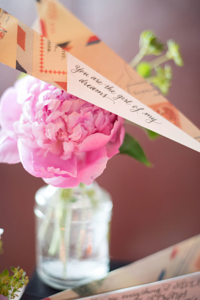 NYC Proposal Photographer Mikkel Paige Photography captures a travel themed marriage proposal in Columbus Circle with calligraphy on paper airplanes.