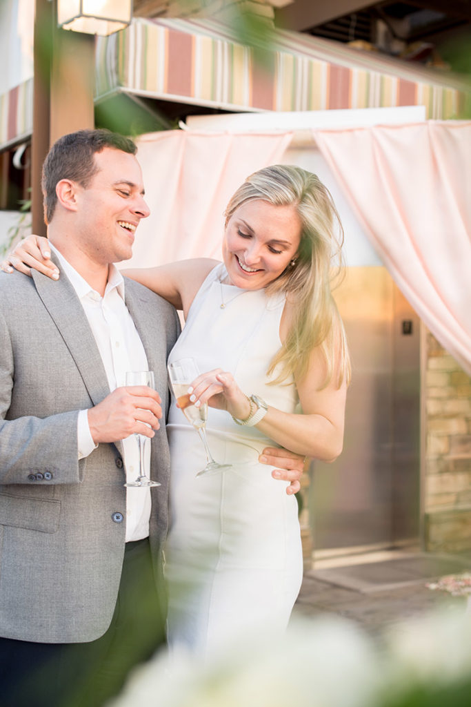 NYC rooftop proposal photos by Mikkel Paige Photography, New York wedding photographer. Champagne toast cheers!
