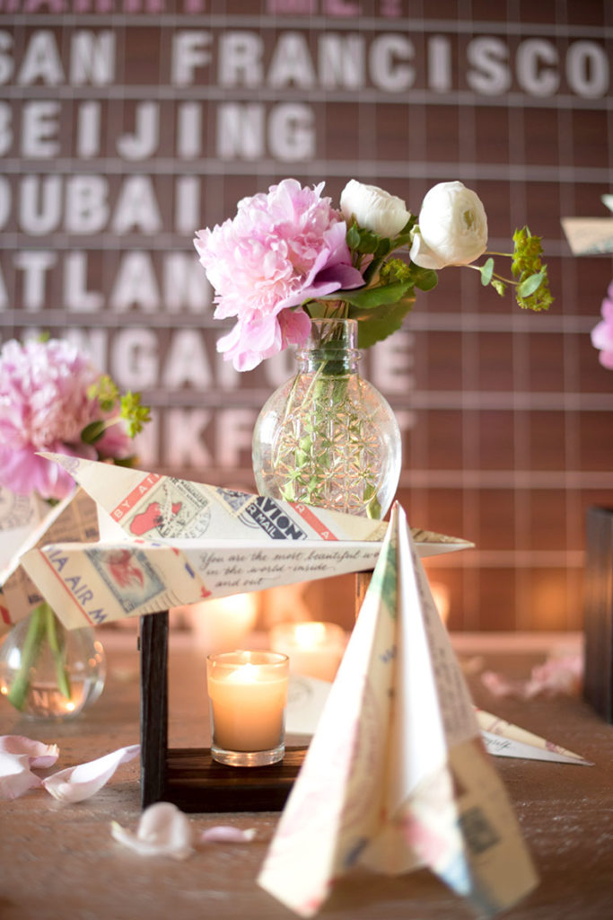 NYC Proposal Photographer Mikkel Paige Photography captures a travel themed marriage proposal in Columbus Circle with calligraphy on paper airplanes.
