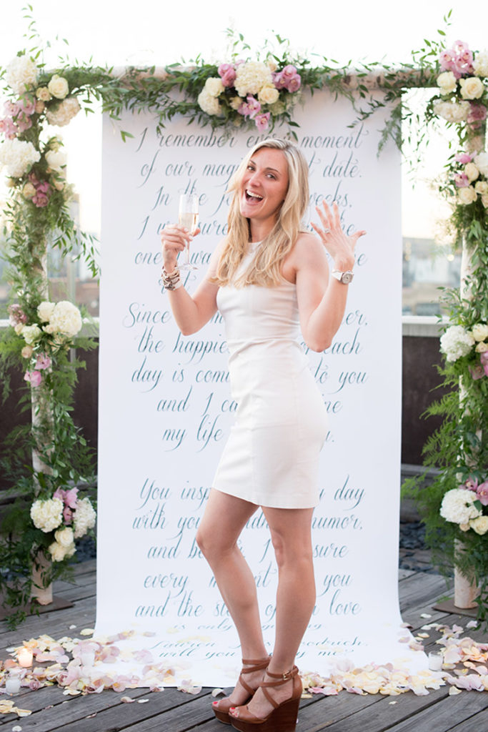 NYC rooftop proposal photos by Mikkel Paige Photography, New York wedding photographer. Emerald cut, halo diamond engagement ring.