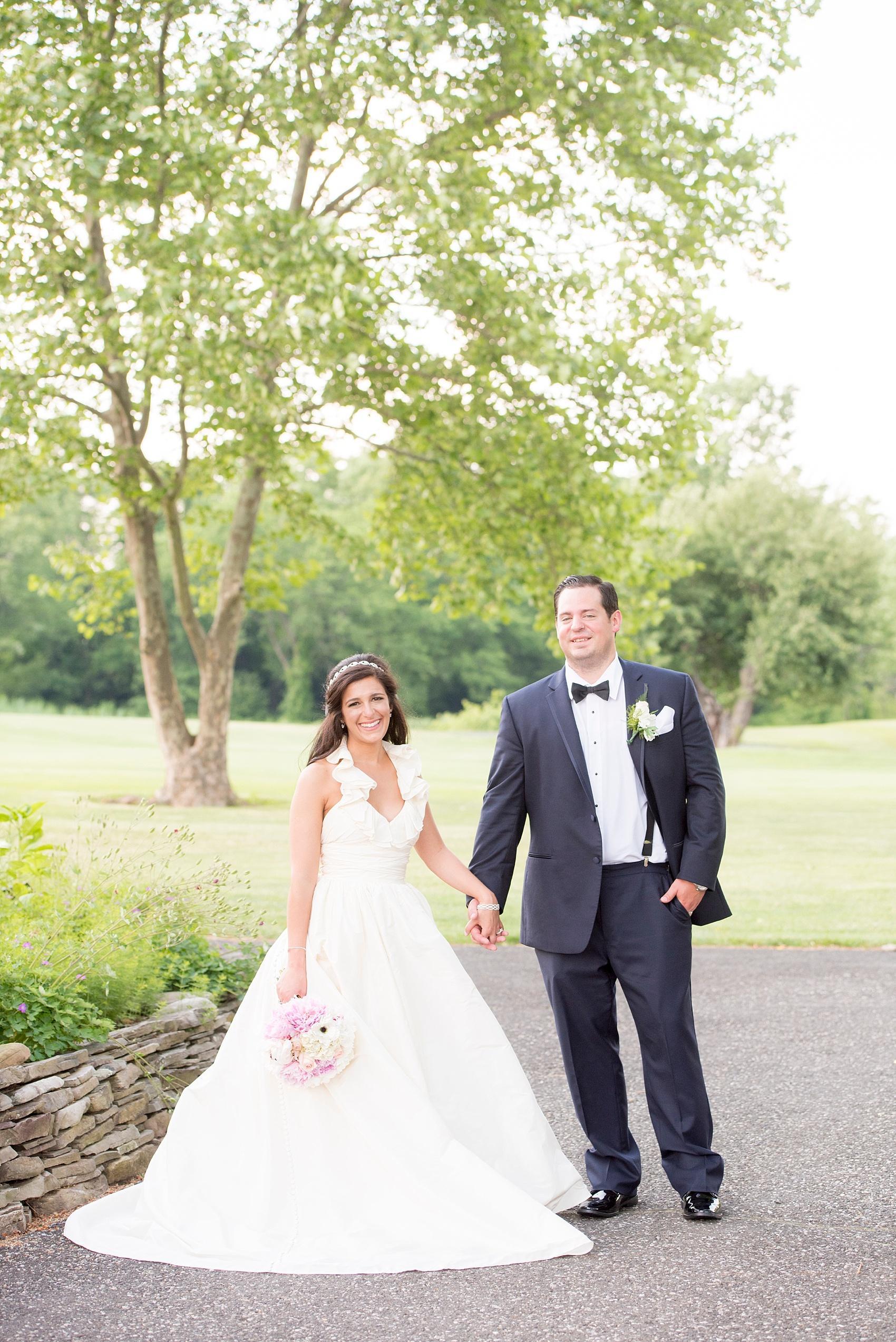 Photo by Mikkel Paige Photography, Raleigh and NYC wedding photographer of a bride and groom in navy and halter Amsale dress at Basking Ridge Country Club.