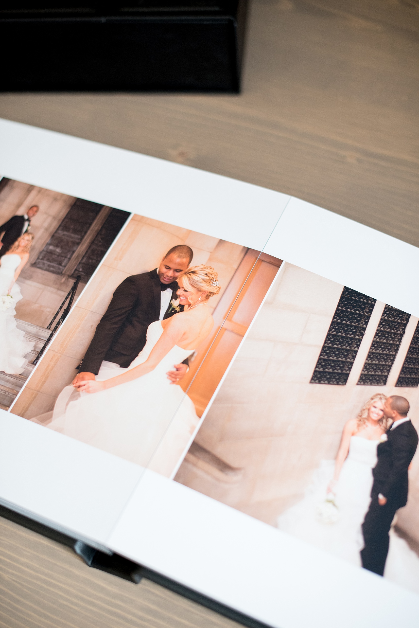 Mikkel Paige Photography photos of a black fine art leather wedding album with subtle Disney "Happily Ever After" theme.