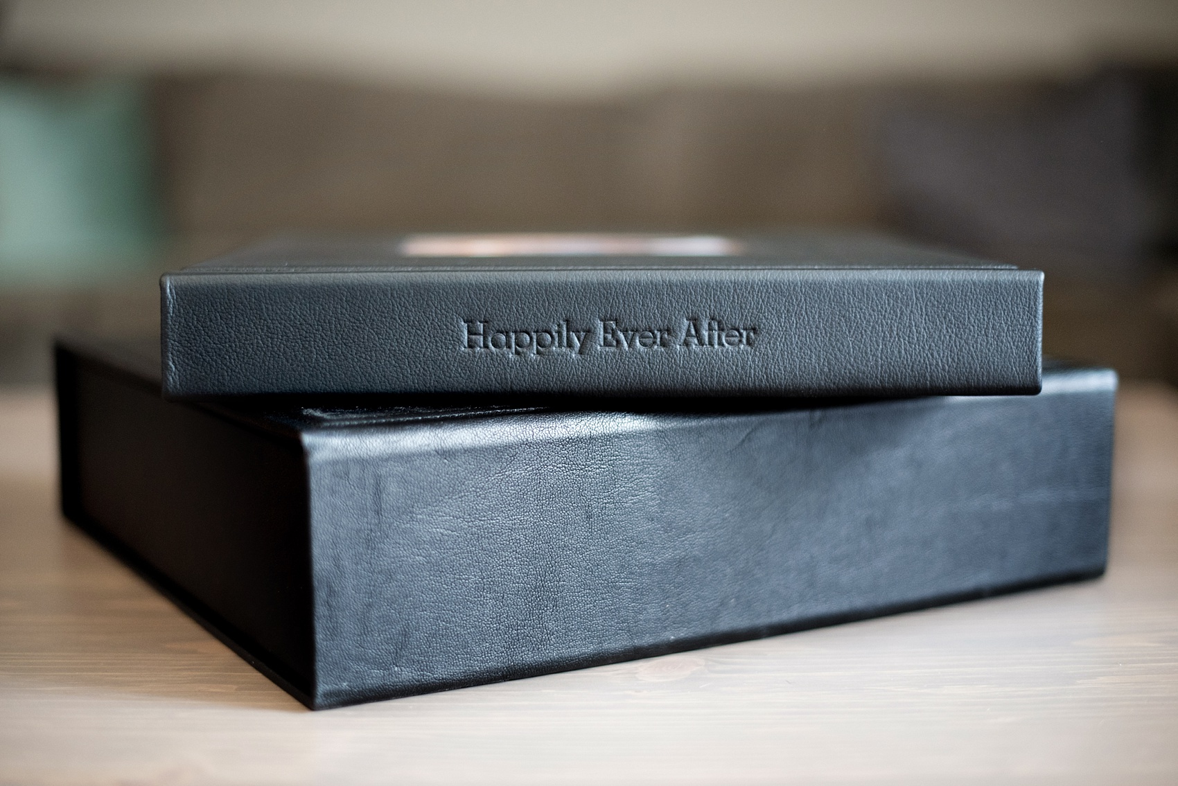 Mikkel Paige Photography photos of a black fine art leather wedding album with subtle Disney "Happily Ever After" theme.