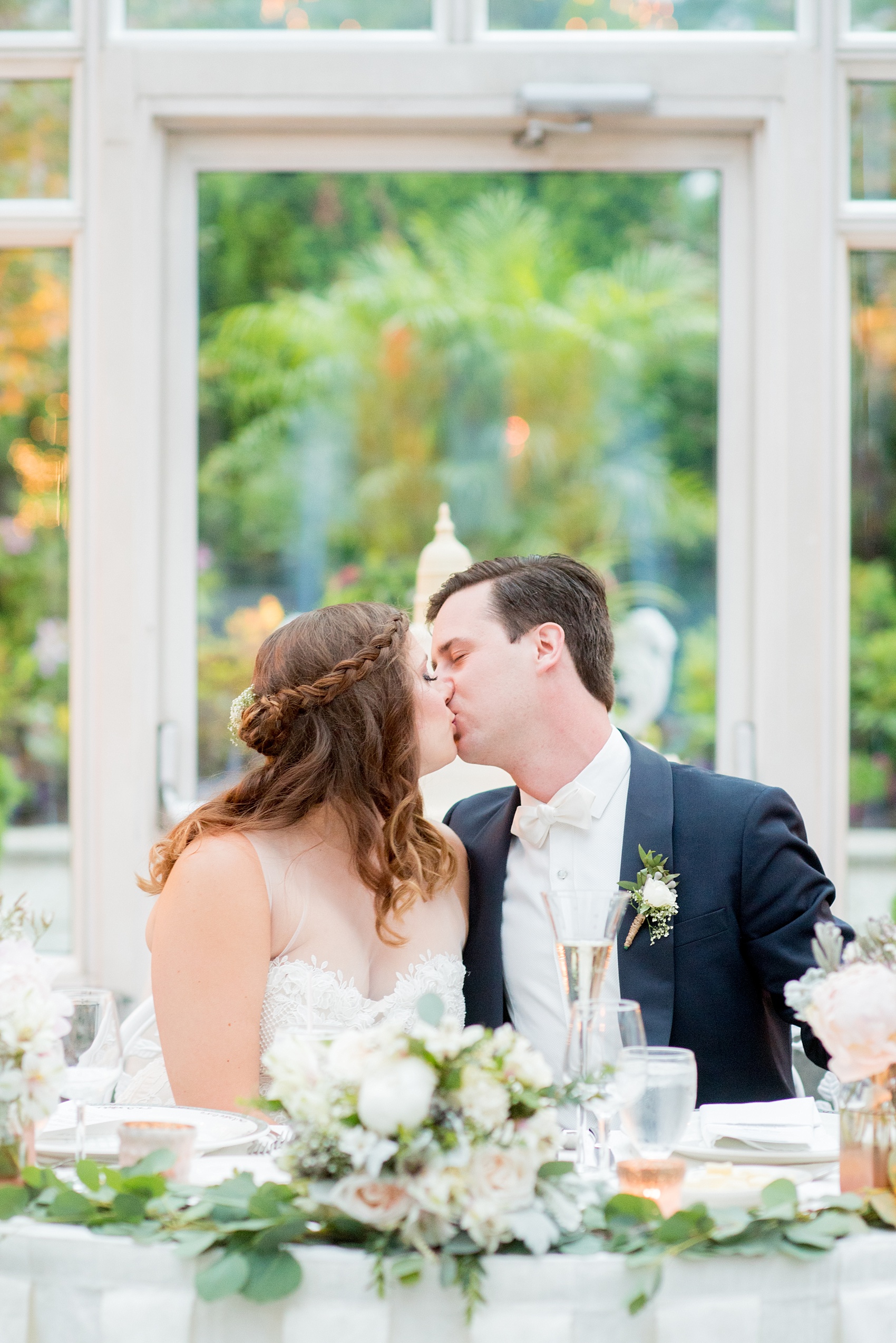Mikkel Paige Photography photo of a wedding at Madison Hotel in NJ. Photo of the bride and groom at their sweetheart table in The Conservatory.