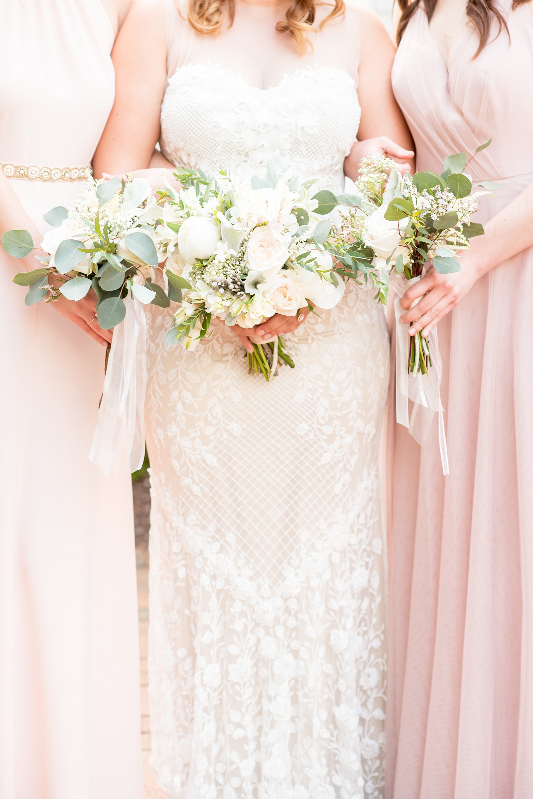 Mikkel Paige Photography photo of a wedding at Madison Hotel in NJ with the bridal party in light pink mismatched dresses with white rose and eucalyptus bouquets with long ribbons and the bride in a beaded BHLDN gown.