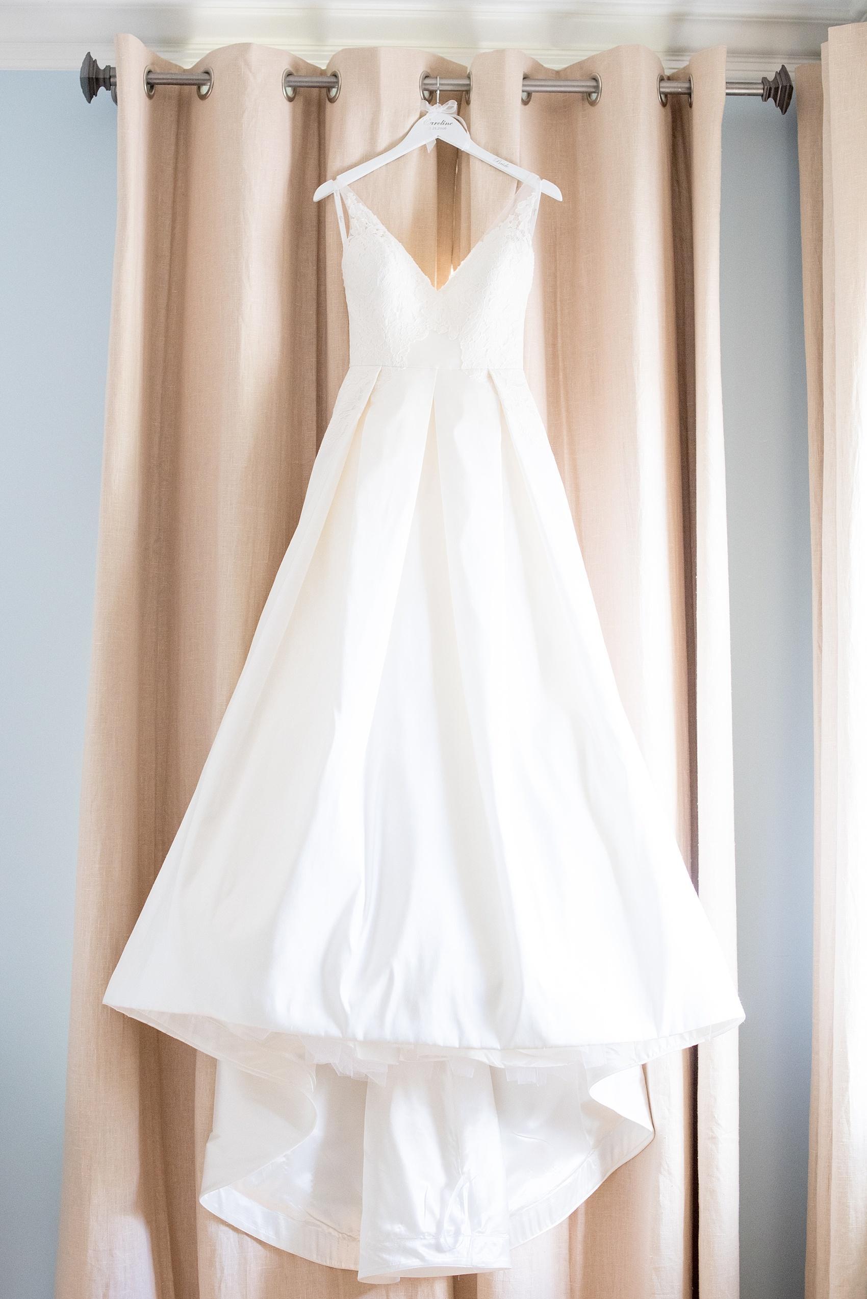 Mikkel Paige Photography pictures of a wedding in downtown Raleigh. Photo of the bridal gown on a custom hanger.