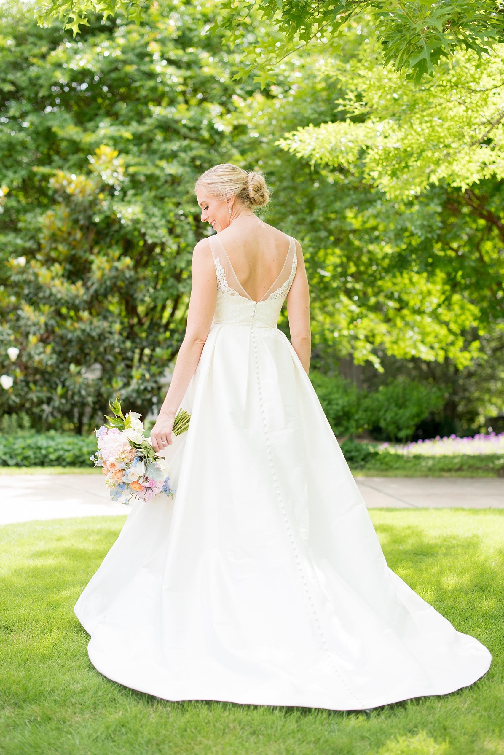 Mikkel Paige Photography pictures of a wedding in downtown Raleigh. Photo of the back of the bride's elegant silk white gown.