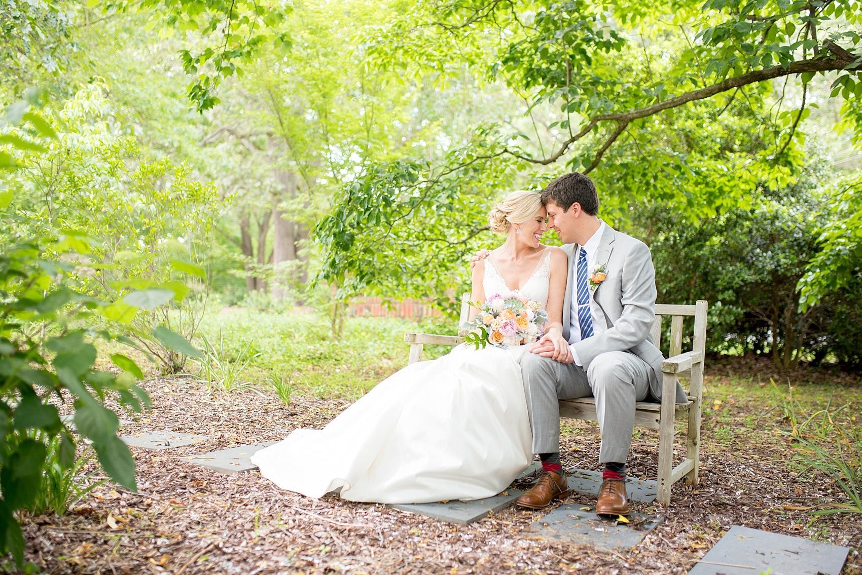 Mikkel Paige Photography pictures of a wedding in downtown Raleigh. Photo of the bride and groom on a bench in her family's garden.