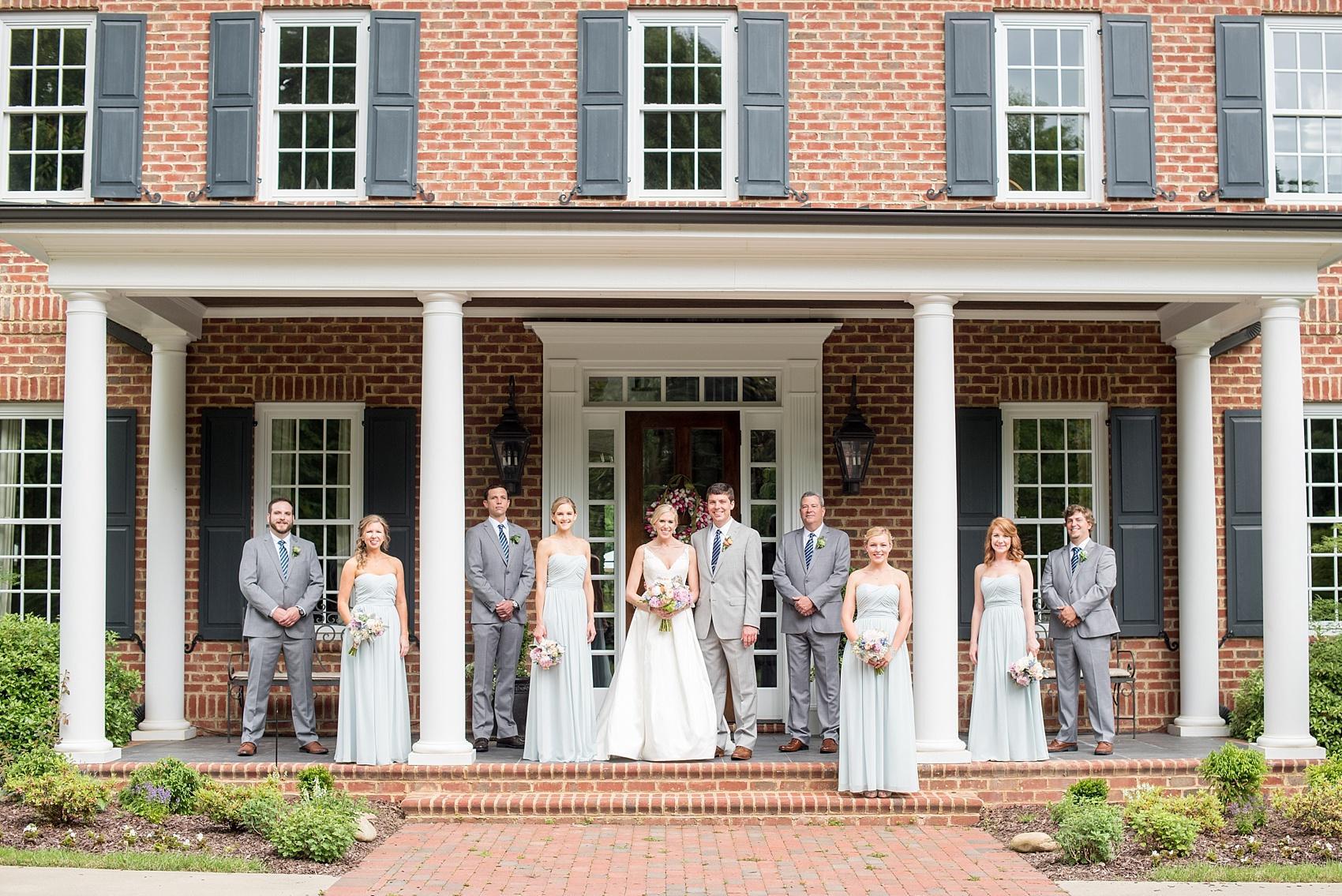 Mikkel Paige Photography photos of a downtown Raleigh wedding. Light blue details with planning by Sally Oakley. Image of the wedding party with the bridesmaids in blue gowns and groomsmen in grey with blue striped ties.