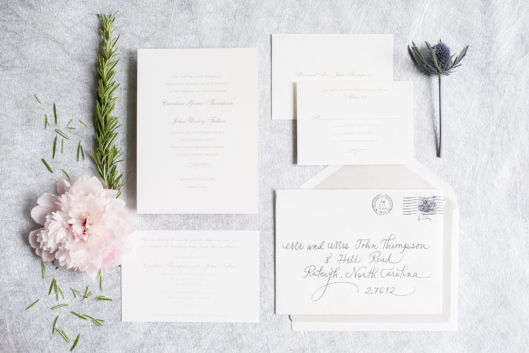 Mikkel Paige Photography photos of a downtown Raleigh wedding. Light blue details with planning by Sally Oakley. Classic white and silver invitation for a Market Hall reception.