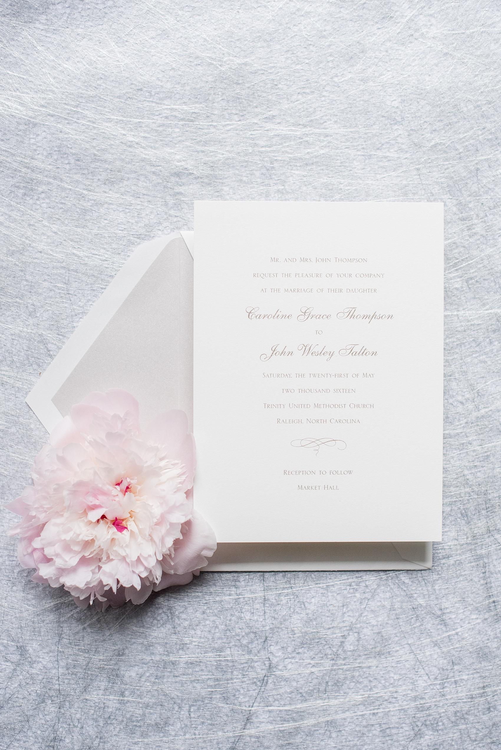 Mikkel Paige Photography photos of a downtown Raleigh wedding. Light blue details with planning by Sally Oakley. Classic white and silver invitation for a Market Hall reception.