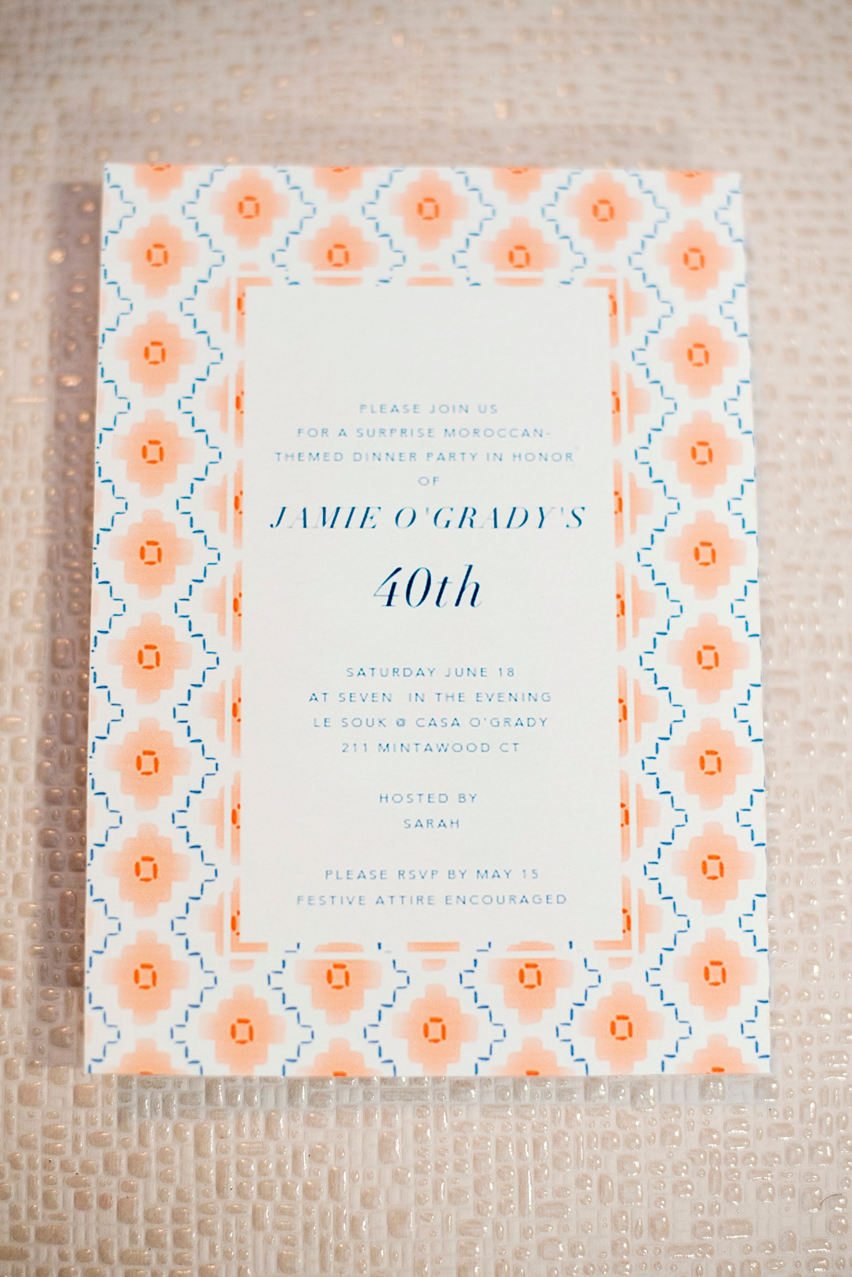 Mikkel Paige Photography photo of Moroccan themed surprise party invitation from Paperless Post and orange and blue pattern.