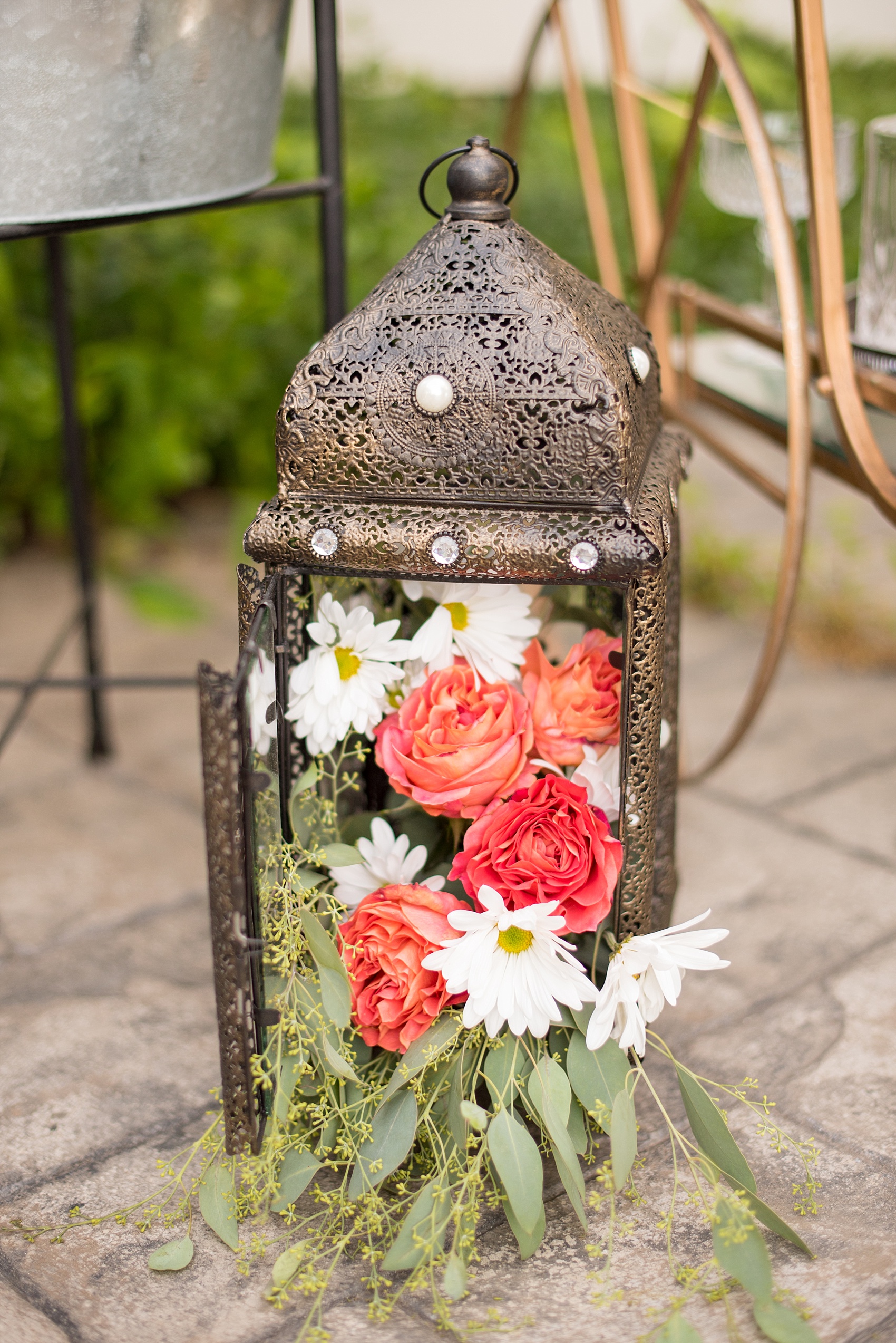 Mikkel Paige Photography photo of Moroccan themed party with flower-filled gold lanterns and bistro lights.