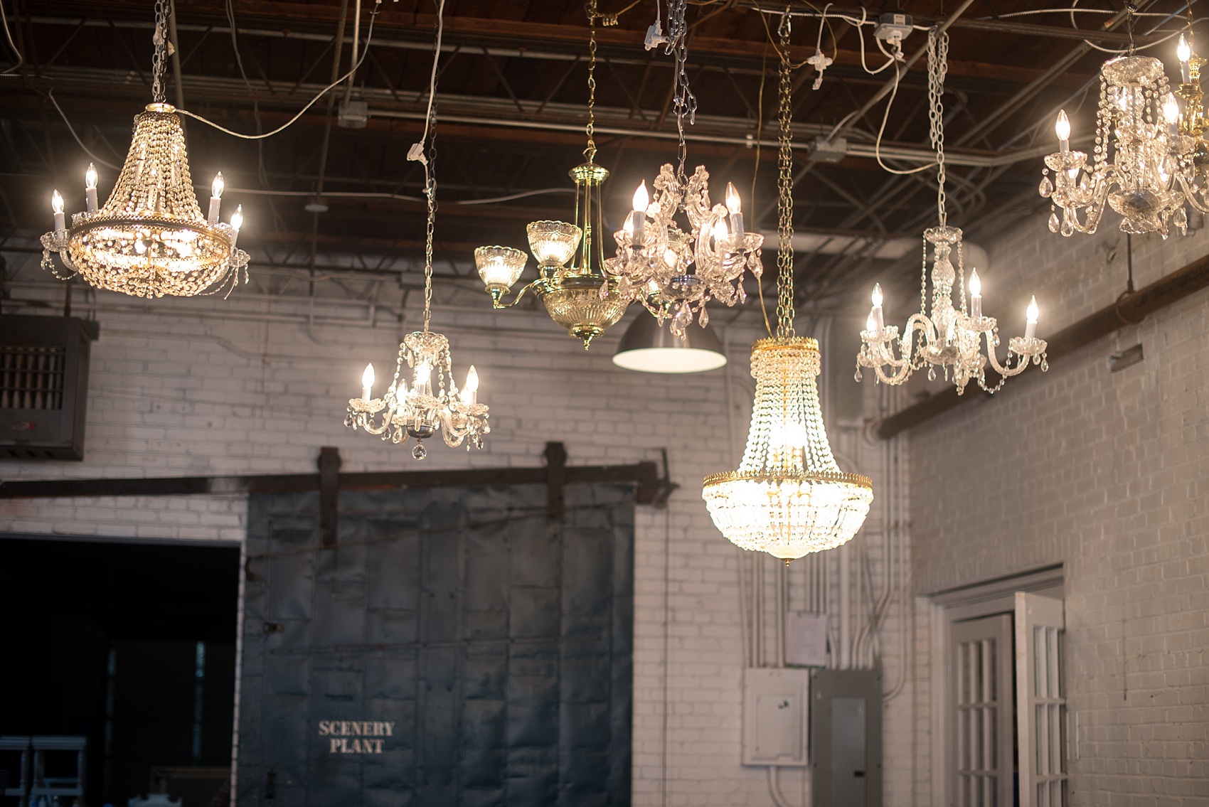 Mikkel Paige Photography photos of vintage furniture renal company Paisley and Jade in Richmond, Virginia. A variety of chandeliers.
