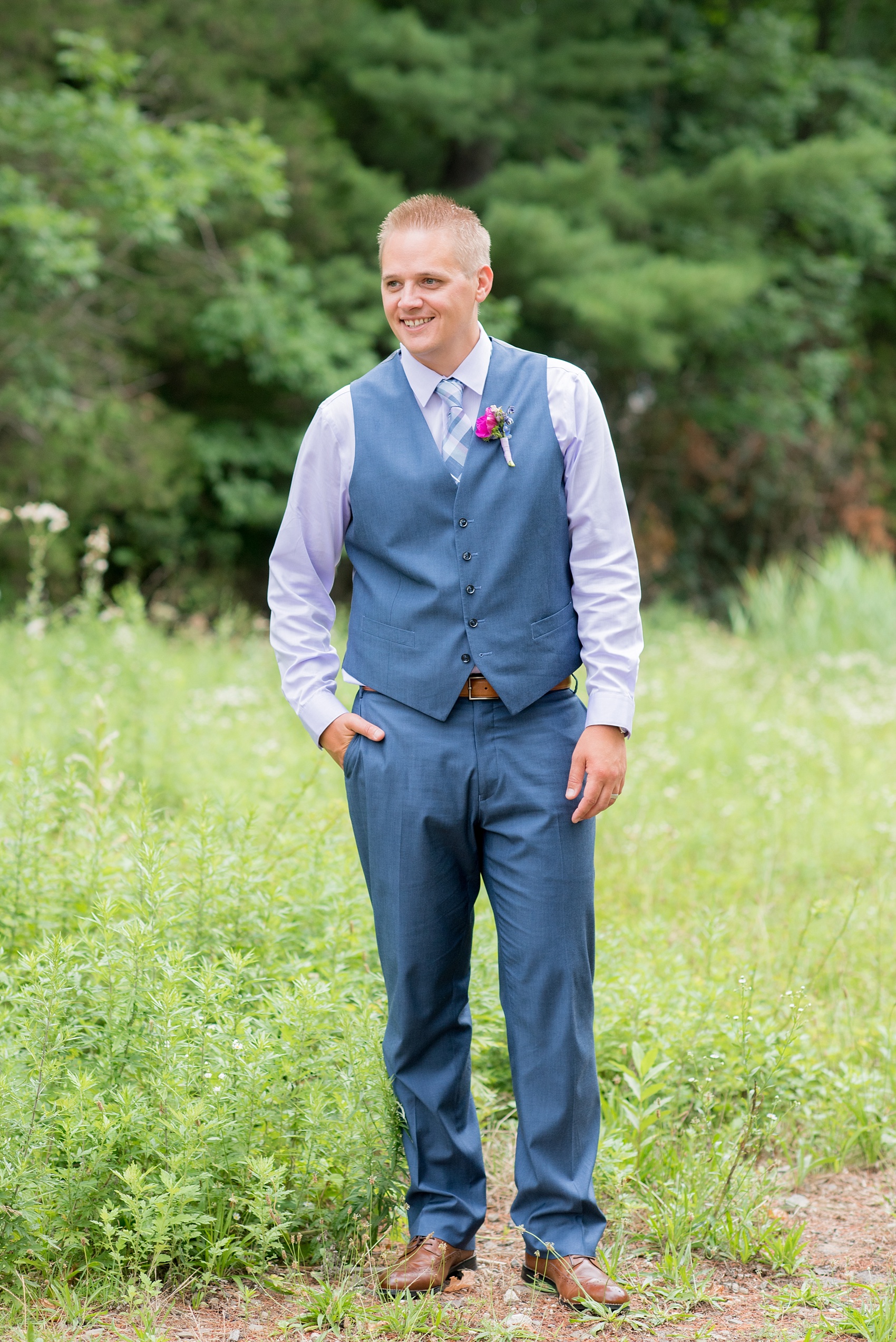 Mikkel Paige Photography photo of an anniversary session with light blue, navy and fuchsia pink accents with a groom in a blue suit and vest. 