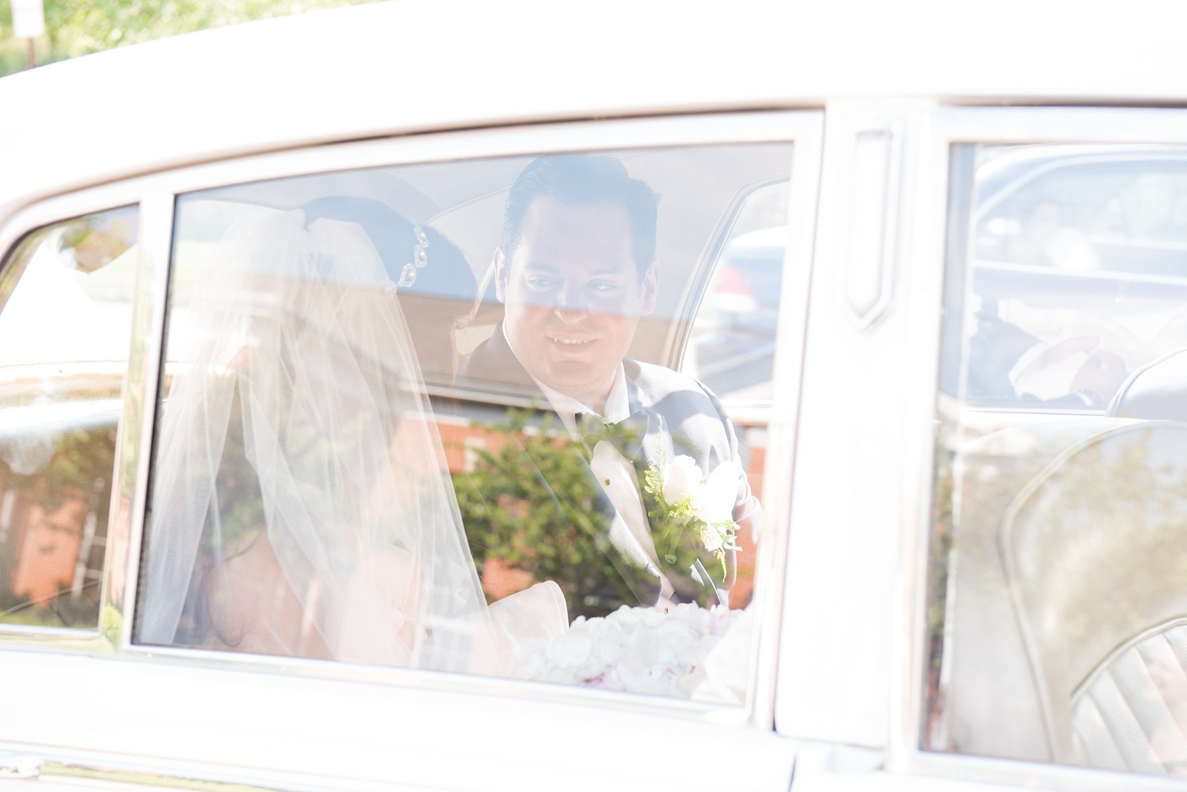 Mikkel Paige Photography photos from a wedding in Basking Ridge, NJ. The bride and groom ride away in a Rolls Royce vintage car.