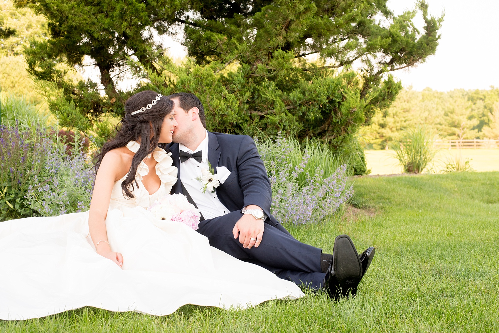 Mikkel Paige Photography photos from a wedding at Basking Ridge Country Club, NJ. The bride in a halter gown and groom in a navy blue suit share a kiss.