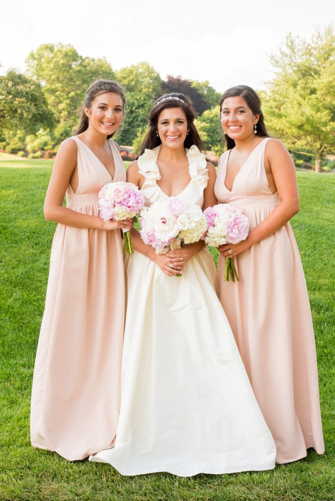 Mikkel Paige Photography photos from a wedding at Basking Ridge Country Club, NJ. The bride and bridesmaids in light pink dresses with peonies.