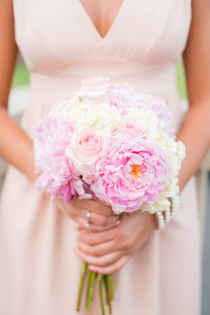 Mikkel Paige Photography photos from a wedding at Basking Ridge Country Club, NJ. The bride and bridesmaids in light pink dresses with peony bouquets.