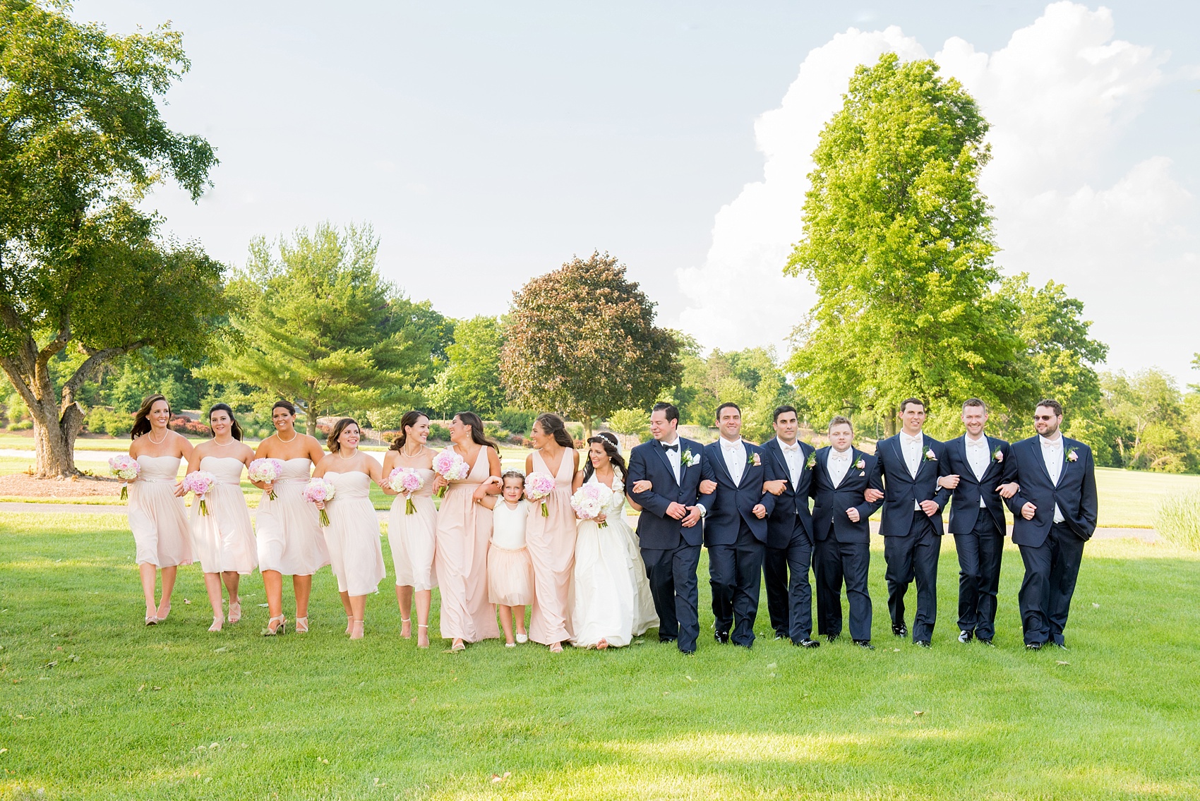 Mikkel Paige Photography photos from a wedding at Basking Ridge Country Club, NJ. The bride and bridesmaids in light pink dresses with peonies and the groomsmen in navy blue suits.