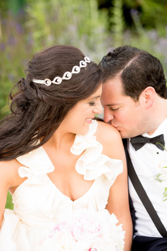 Mikkel Paige Photography photos from a wedding at Basking Ridge Country Club, NJ. The bride in a halter gown and groom in a navy blue suit share a kiss.