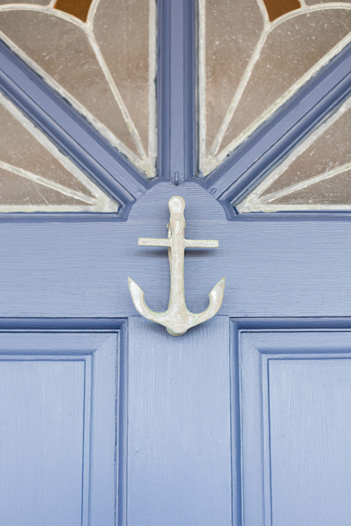 Mikkel Paige Photography beach engagement photos in Bay Head, NJ. The houses on the beach with anchor door knocker detail.
