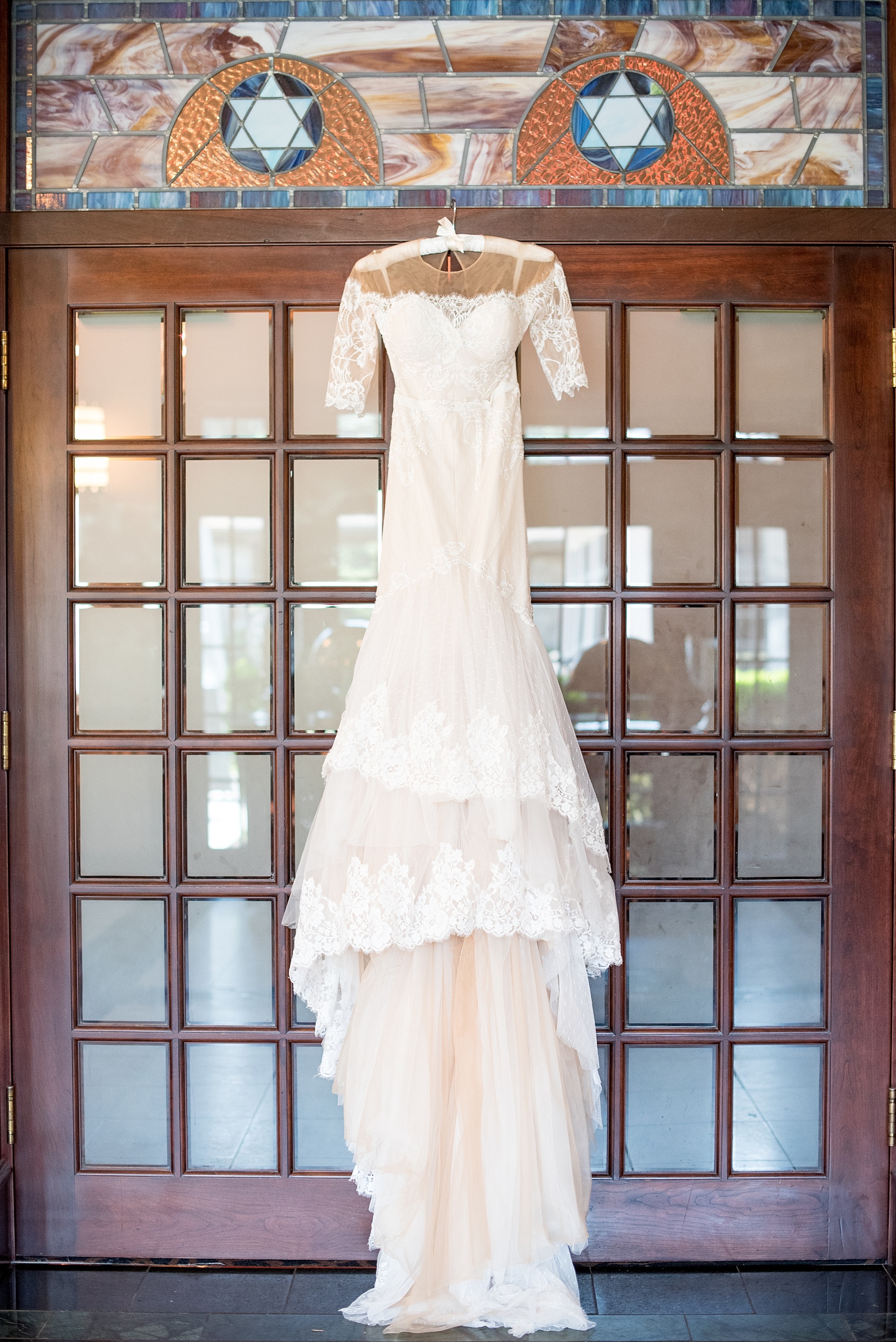 Mikkel Paige Photography photo of the bride's unique long sleeve wedding gown by Inbal Dror on her wedding day at Temple Emanu-El in Closter, NJ.